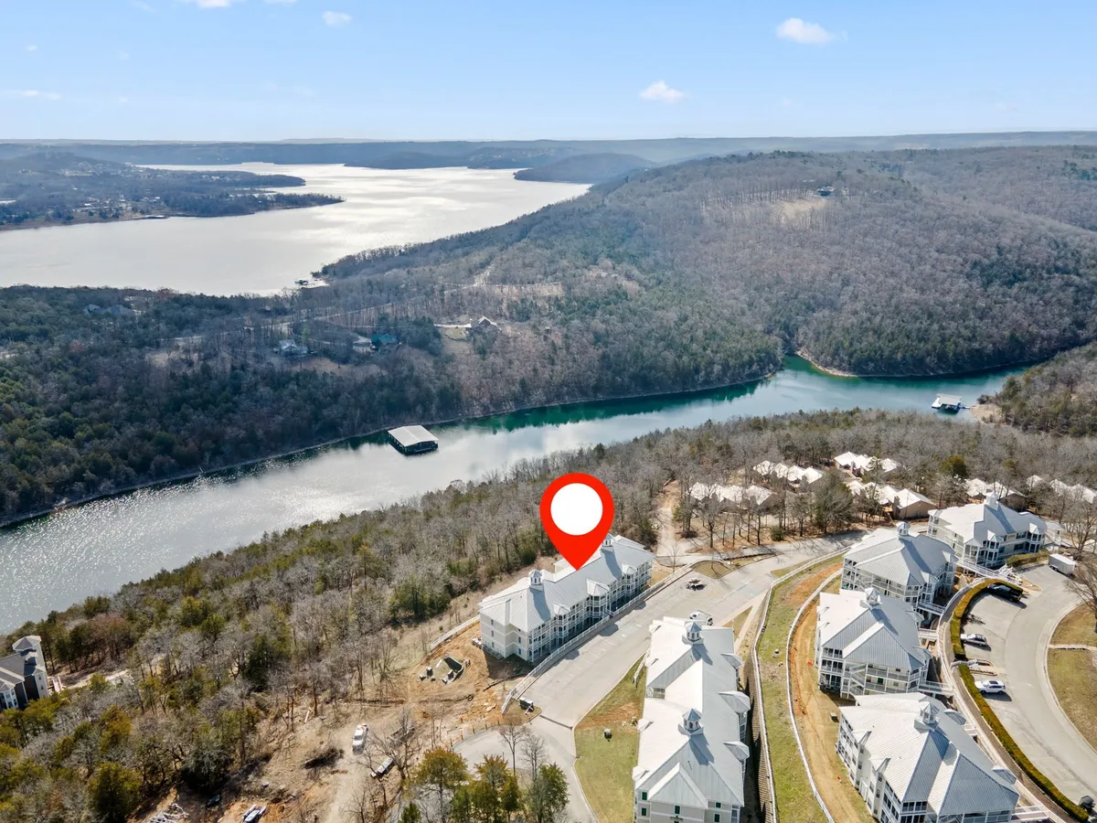 A wide view of the lake, framed by surrounding hills and a neighborhood of homes. The peaceful water and natural scenery evoke a sense of serenity, ideal for lakeside walks, fishing, or quiet moments together.